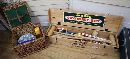 A modern Jacques croquet set, cased and a picnic set in a wicker basket with bottle compartments